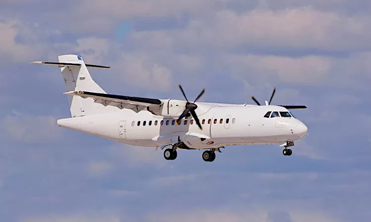 white body propeller aircraft in flight